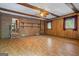 Bright living room features exposed brick, laminate floors, and wood beams at 725 & 761 School Road, Hampton, GA 30228