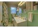 A bathroom with patterned wallpaper and tile at 1349 Springwood Nw Dr, Conyers, GA 30012
