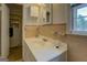 Well-lit bathroom featuring a single sink vanity and neutral tile at 1349 Springwood Nw Dr, Conyers, GA 30012