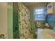 A bathroom with a window and patterned wallpaper at 1349 Springwood Nw Dr, Conyers, GA 30012