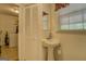 Cozy bathroom with a pedestal sink and natural light at 1349 Springwood Nw Dr, Conyers, GA 30012