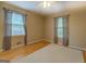 A carpeted bedroom with two windows and neutral walls at 1349 Springwood Nw Dr, Conyers, GA 30012