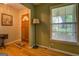 Inviting foyer features hardwood floors, a classic door, and natural light from the nearby window at 1349 Springwood Nw Dr, Conyers, GA 30012