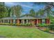 Inviting brick home with a welcoming front porch and well-maintained landscaping, blending charm and curb appeal at 1349 Springwood Nw Dr, Conyers, GA 30012