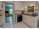 Traditional kitchen with white cabinetry and tile floors open to the living room at 1349 Springwood Nw Dr, Conyers, GA 30012