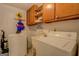 Functional laundry room with washer, dryer, and ample storage at 1349 Springwood Nw Dr, Conyers, GA 30012