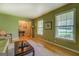 Spacious living room with hardwood floors, large windows, and open access to other rooms, offering ample natural light at 1349 Springwood Nw Dr, Conyers, GA 30012