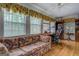 Bright living room with large windows, hardwood floors, and built-in bookcases at 1349 Springwood Nw Dr, Conyers, GA 30012