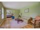Living room with hardwood floors, a neutral rug, and green painted walls creating a bright and airy space at 1349 Springwood Nw Dr, Conyers, GA 30012