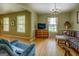 Cozy living room with hardwood floors, chandelier, and sunny windows at 1349 Springwood Nw Dr, Conyers, GA 30012