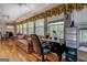 Bright office space featuring hardwood floors, a classic desk, and sun-drenched windows with decorative valances at 1349 Springwood Nw Dr, Conyers, GA 30012