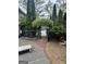 Charming backyard entrance with brick pathway and lush greenery at 374 Persimmon Dr, Sharpsburg, GA 30277