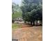 Backyard with an outbuilding, trees and concrete at 374 Persimmon Dr, Sharpsburg, GA 30277