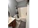 Upstairs bathroom includes a shower-tub combo, neutral wall color, and gray flooring at 374 Persimmon Dr, Sharpsburg, GA 30277