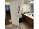 Bright bathroom with cherry vanity cabinet, white marble countertop, and an adjacent bedroom area at 374 Persimmon Dr, Sharpsburg, GA 30277