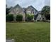 Beautiful brick home with well-manicured lawn and mature landscaping at 374 Persimmon Dr, Sharpsburg, GA 30277