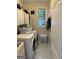 Bright laundry room featuring a window, washer and dryer, cabinets, and a convenient sink at 374 Persimmon Dr, Sharpsburg, GA 30277