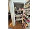 Walk-in pantry with shelves is packed with an assortment of food in a well-stocked storage area at 374 Persimmon Dr, Sharpsburg, GA 30277
