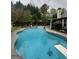 Sparkling pool with diving board and adjacent patio seating area at 374 Persimmon Dr, Sharpsburg, GA 30277