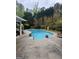 Inviting backyard pool surrounded by a concrete patio and lush landscaping at 374 Persimmon Dr, Sharpsburg, GA 30277