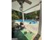 Covered outdoor patio with a view of the pool and a seating area with a view at 374 Persimmon Dr, Sharpsburg, GA 30277