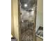 Shower features pebble floor, marbled tile, a shower head, and clear glass enclosure at 374 Persimmon Dr, Sharpsburg, GA 30277