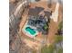 Aerial view of the home's back yard, deck and a kidney shaped pool with a fence around it at 108 Turnberry Trce, Sharpsburg, GA 30277