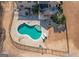 Aerial view of the kidney shaped pool and deck in the backyard with a wrought iron fence at 108 Turnberry Trce, Sharpsburg, GA 30277