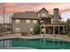 Lovely home back exterior at dusk featuring a sparkling pool, deck, and outdoor entertaining space at 108 Turnberry Trce, Sharpsburg, GA 30277
