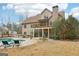 Spacious backyard with a refreshing pool, a deck perfect for outdoor entertaining, and lush greenery at 108 Turnberry Trce, Sharpsburg, GA 30277