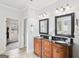 Bathroom featuring a double vanity with black granite countertops and dark wood cabinets at 108 Turnberry Trce, Sharpsburg, GA 30277