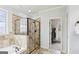 Spacious bathroom featuring a walk-in closet, walk-in shower with tile surround, and a soaking tub at 108 Turnberry Trce, Sharpsburg, GA 30277