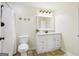 Bright bathroom featuring a vanity with sink, mirror, toilet, and shower with neutral walls at 108 Turnberry Trce, Sharpsburg, GA 30277