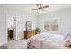 Bright bedroom featuring a ceiling fan and a view of trees from the window at 108 Turnberry Trce, Sharpsburg, GA 30277