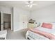 Bright bedroom with white trim, ceiling fan, carpeted floors, and a large closet at 108 Turnberry Trce, Sharpsburg, GA 30277