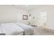 Bright bedroom with neutral walls, carpet, a bed, a walk-in closet, and bathroom access at 108 Turnberry Trce, Sharpsburg, GA 30277