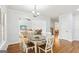 Open concept breakfast nook view into adjacent living room and staircase at 108 Turnberry Trce, Sharpsburg, GA 30277