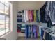 Bright closet featuring shelving units and clothing racks next to a window at 108 Turnberry Trce, Sharpsburg, GA 30277