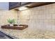 Close-up of the speckled granite countertops and decorative tile backsplash at 108 Turnberry Trce, Sharpsburg, GA 30277