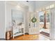 Inviting foyer boasts an open door to the outside and hardwood floors at 108 Turnberry Trce, Sharpsburg, GA 30277