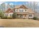 Inviting two-story home with a charming front porch and well-manicured landscaping at 108 Turnberry Trce, Sharpsburg, GA 30277