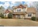 Inviting two-story home with a charming front porch and well-manicured landscaping at 108 Turnberry Trce, Sharpsburg, GA 30277