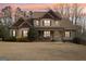 Inviting two-story home with a charming front porch and well-manicured landscaping at dusk at 108 Turnberry Trce, Sharpsburg, GA 30277