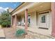 Inviting front porch with stone accents and a charming seating area for relaxing and enjoying the outdoors at 108 Turnberry Trce, Sharpsburg, GA 30277