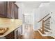 Bright hallway showcasing wood floors, adjacent dining area, and staircase at 108 Turnberry Trce, Sharpsburg, GA 30277
