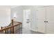Upstairs hallway leading to bedroom with a view of the bedroom through open door at 108 Turnberry Trce, Sharpsburg, GA 30277