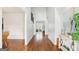 Long hallway boasts hardwood floors and leads to multiple rooms at 108 Turnberry Trce, Sharpsburg, GA 30277