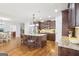 Open kitchen with island seating and easy access to dining and living areas at 108 Turnberry Trce, Sharpsburg, GA 30277
