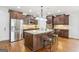 Open kitchen with dark cabinetry, stainless steel appliances, and a large island at 108 Turnberry Trce, Sharpsburg, GA 30277