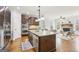 Open kitchen featuring granite countertops, stainless steel appliances, and a view to the living area at 108 Turnberry Trce, Sharpsburg, GA 30277